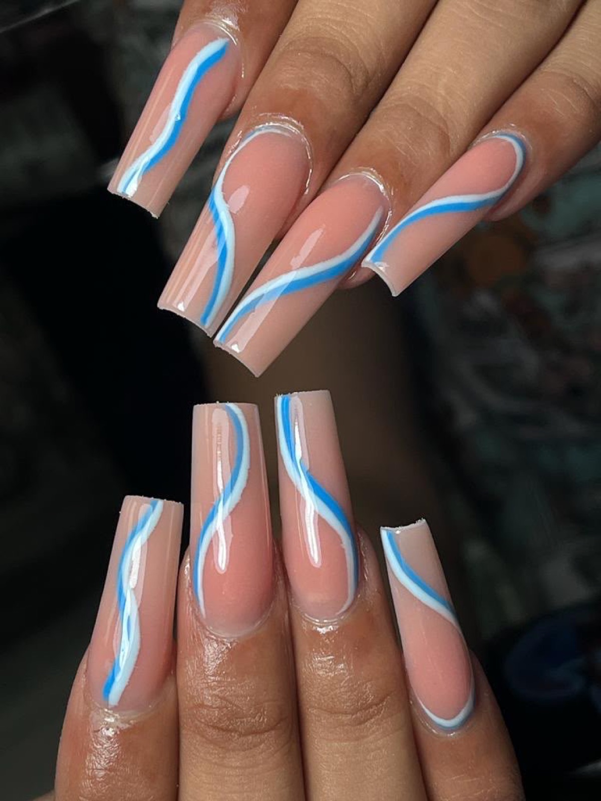 Nude nails with blue and white curves